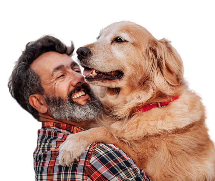middle aged man hugging a very large and friendly golden retriever